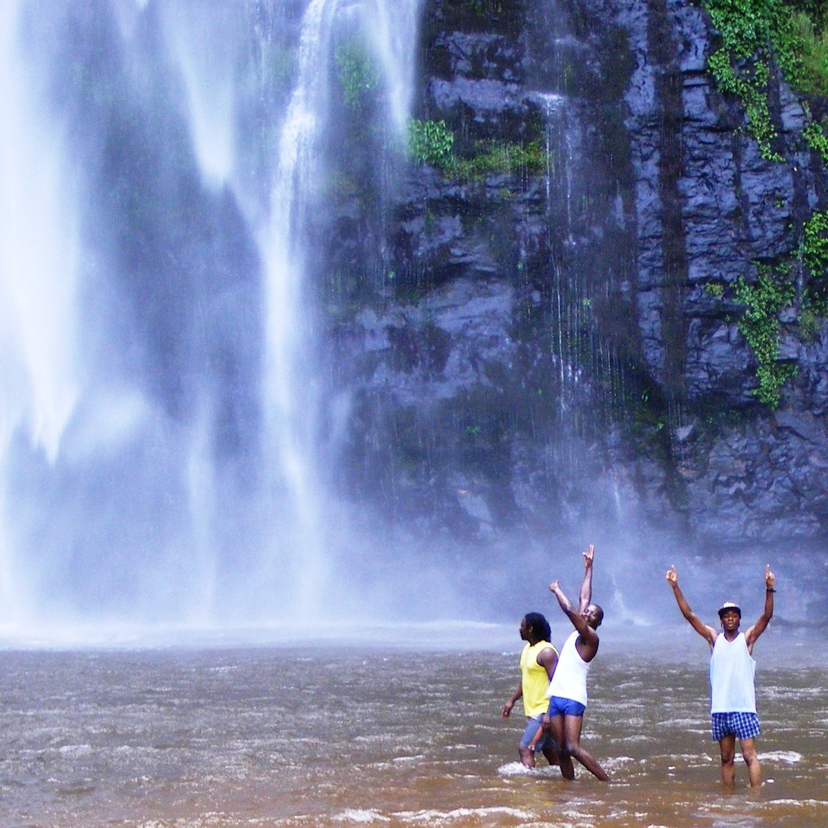 Guests and guide in the pool below Wli Falls